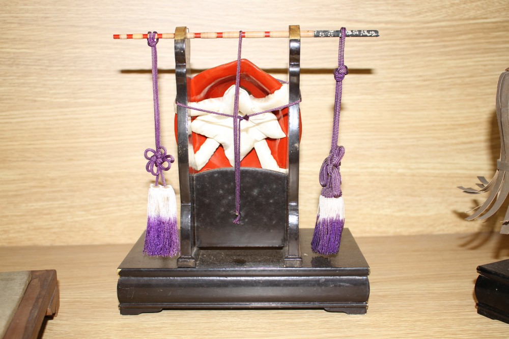 A Japanese late Meiji period composition and fabric figure of a boy farmer holding an adze with puppy seated nearby, mounted on display